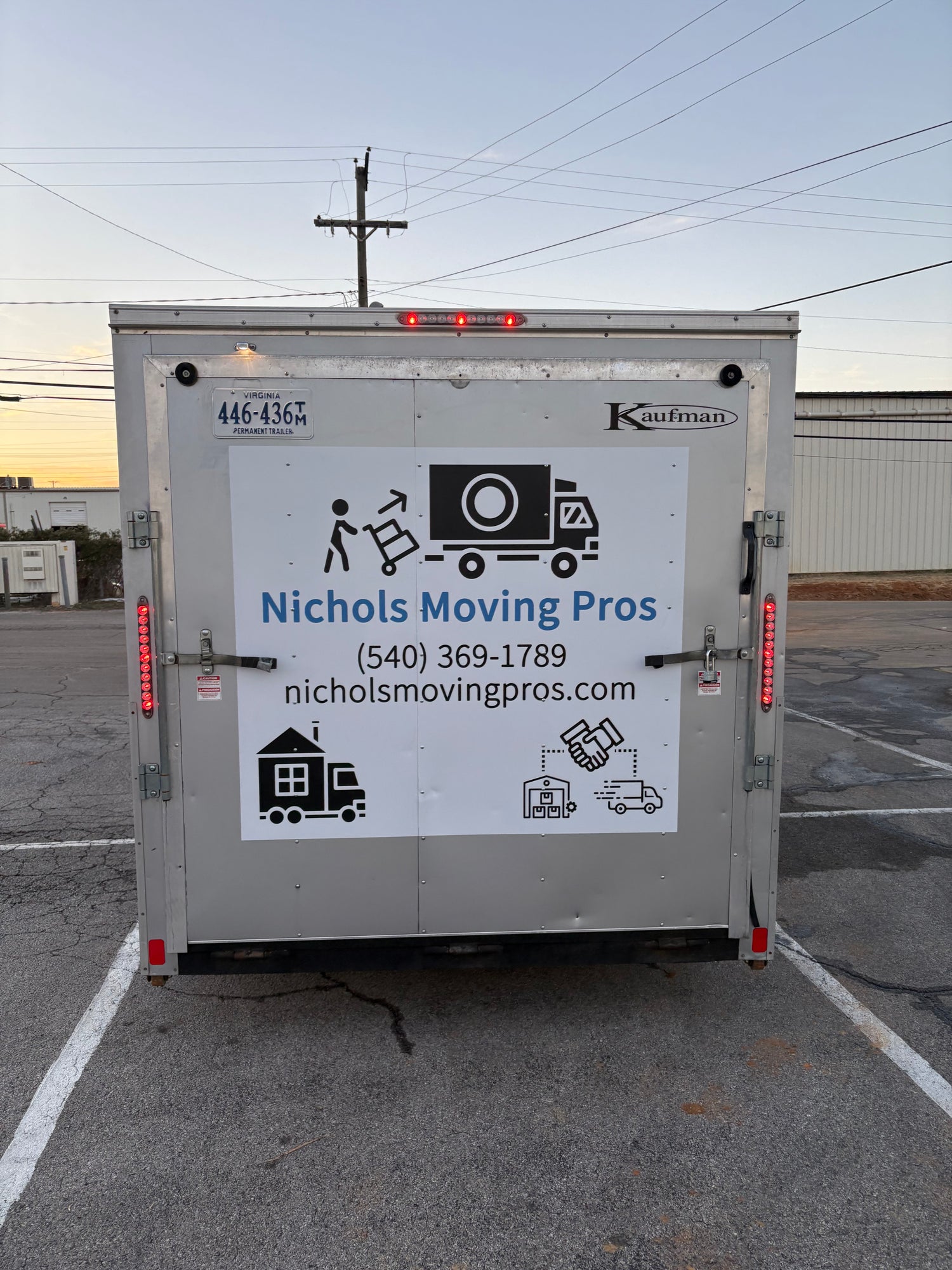"A clean and organized moving truck trailer being loaded by movers, showcasing a seamless moving process."