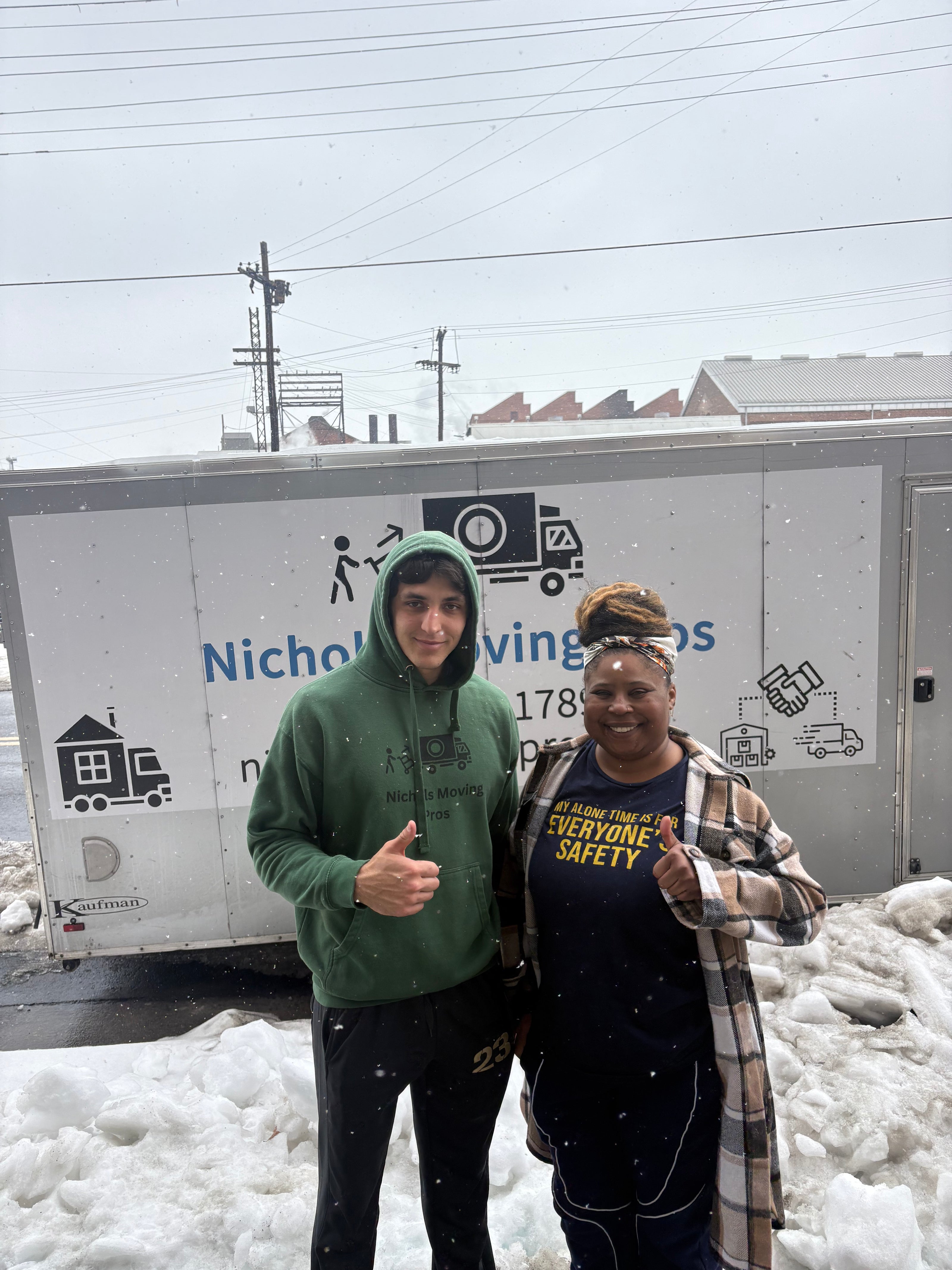 happy customer with nichols moving pros owner in the snow